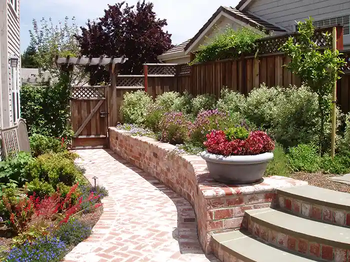 Landscape construction including bushes, plants and stone walkway